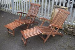 Two teak sun loungers, labelled Rowlinson garden products