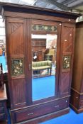 A Victorian Aesthetic four piece mahogany bedroom suite comprising mirror door robe, bergere