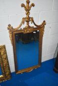 A gilded wood framed wall mirror, having decorative urn finial to top and swags to sides, approx