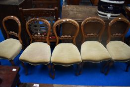 A set of five Victorian mahogany framed salon chairs havung balloon and rail backs, later dralon