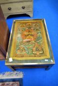 A vintage coffee table having deity decoration, approx 89 x 62cm