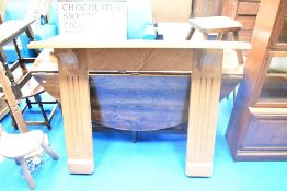 An Arts & Crafts golden oak fire surround by 'Mouseman' Thompson , having typical mouse motif to