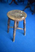 A traditional oak stool having turned legs, height approx. 52cm
