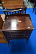A Regency revival three drawer music cabinet, having stained frame.