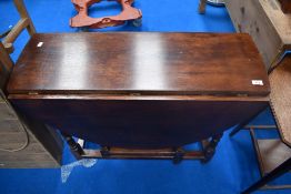 A traditional styled oak gateleg dining table.