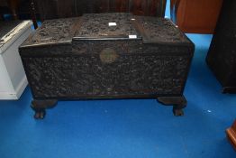 An Oriental camphor wood blanket box having extensively carved dragon decoration, width approx 90cm