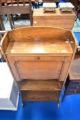 An Arts and Crafts style golden oak bureau bookshelf, of narrow proportions, width approx 56cm.