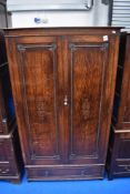 An early 20th Century oak wardrobe having beaded decoration, width 98cm