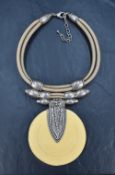 A vintage Debraine statement necklace, the step moulded central yellow medallion adorned with