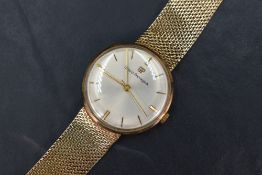 A gent's 9ct gold dress watch by Girard Perragaux having a baton numeral dial with gold hands on a