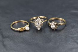 Three yellow metal rings stamped 9ct, two having cubic zirconia clusters the other having cultured