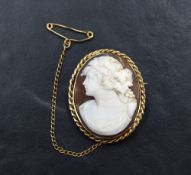 A conch shell cameo brooch depicting a bacchante maiden in a decorative 9ct rose gold mount,
