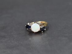 An opal and sapphire trilogy ring, the central circular opal cabochon flanked by two round cut