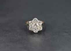 An impressive 18ct white gold diamond cluster ring, the central round brilliant cut diamond