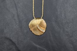 A 1980's Christian Dior diamante set gold plated scallop shell pendant and chain bearing Dior tag,