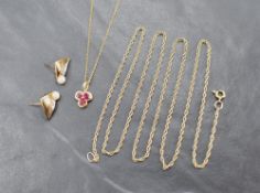 A 9ct gold pendant set with three rubies in a clover motif on a 9ct gold chain, sold along with a