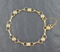 An 18ct gold bracelet having eight brilliant cut diamonds in collared set links with further loop