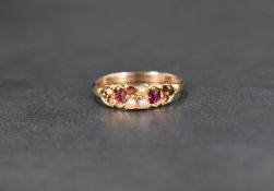 A seed pearl and ruby ring, the four central square set seed pearls flanked by two oval cut rubies