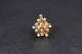 A modern 18ct gold diamond ring, the sixteen round cut diamonds set in a contemporary multi-level