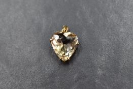 A citrine heart pendant set in a 9ct gold claw mount, approximately 1.5cm W x 2.5cm L including