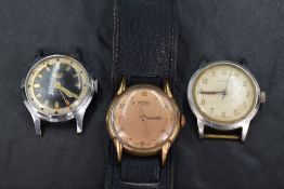 A group of three watches comprising a Garrard watch face having a champagne dial and Arabic numerals