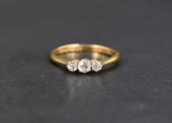 A diamond trilogy ring having three old cut diamonds in claw set mounts, approx 0.225ct total on a