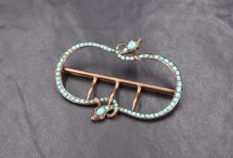 A 19th century yellow metal turquoise set double serpent belt buckle, the two intertwined snakes set