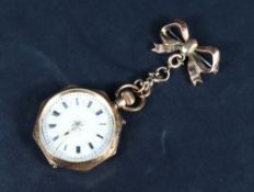 A small open face pocket watch, the circular dial within an octagonal case having Roman numerals and