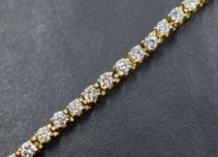 An 18ct gold and diamond tennis bracelet having forty six brilliant cut diamonds in 4 claw set box