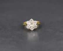 A seven stone brilliant cut diamond daisy cluster ring, total approx 1.35ct in a raised claw set
