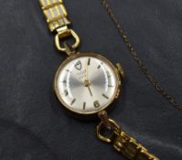 A lady's 1970's yellow metal wristwatch by Tudor having baton & Arabic numeral dial to champagne