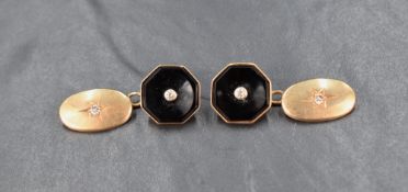 A pair of yellow metal cufflinks presumed to be gold, each with one octagonal black stone set