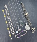 An assortment of silver jewellery including a large moss agate necklace, a floral engraved locket,