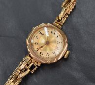 A 9ct gold cased wristwatch, the circular champagne dial with Arabic numerals on an expanding