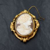 A shell cameo brooch depicting a lady in profile, possibly the Roman Goddess Flora, adorned with
