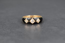 A Victorian yellow metal mourning ring having a trio of old cut diamonds in pave set square