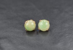 A pair of 9ct gold jade stud earrings, the jade cabochons in a four prong setting, 3g