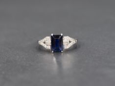 An early 20th century sapphire and diamond ring, the central baguette cut sapphire flanked by two