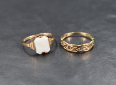 Two 9ct gold rings, one being of pierced band form, the other having a faux opal panel, size P/Q &