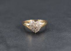 A diamond 'heart' cluster ring, the pave set diamonds totalling approximately 0.25cts in a heart