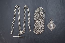 A silver curb link watch chain with T bar approx 16', a white metal muff chain, approx 68' and a