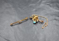 Two yellow metal brooches, one depicting a bird of prey with a turquoise cabochon, the other of a