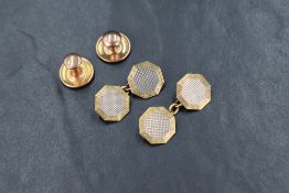 A pair of yellow metal cufflinks of octagonal form having a central white gold central panel with