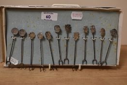 A collection of 20th Century white metal cocktail picks of South American design, each measuring 9cm