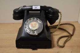 A 20th Century bakelite rotary dial telephone