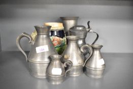 An assorted collection of 19th Century pewter ware, to include an Austen & Son noggin pitcher,