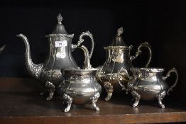 Two Victorian style silver plated footed coffee or tea pots, the largest measures 26cm tall, a cream