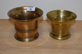 Two 19th Century brass mortar bowls of typical turned form, the largest measures 10cm high