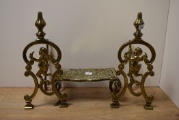 A pair of 20th Century cast gilt metal andirons/fire dogs modelled as winged cherubs, measuring 32cm