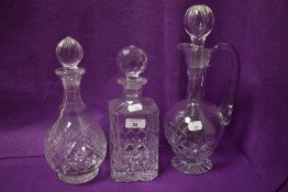 Three 20th Century cut glass spirit decanters and jug, the largest measures 30cm high